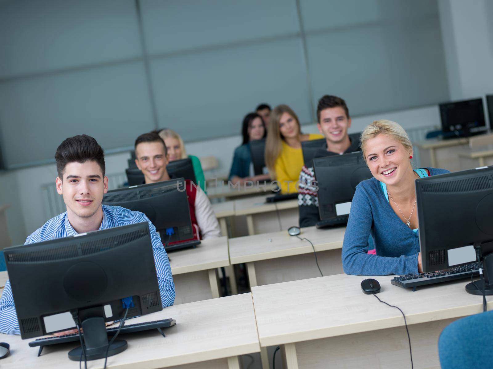 students group in computer lab classroom by dotshock