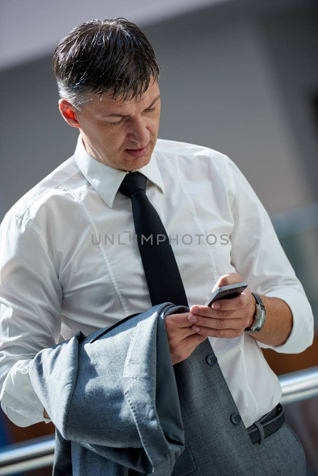 business man using phone at modern office space