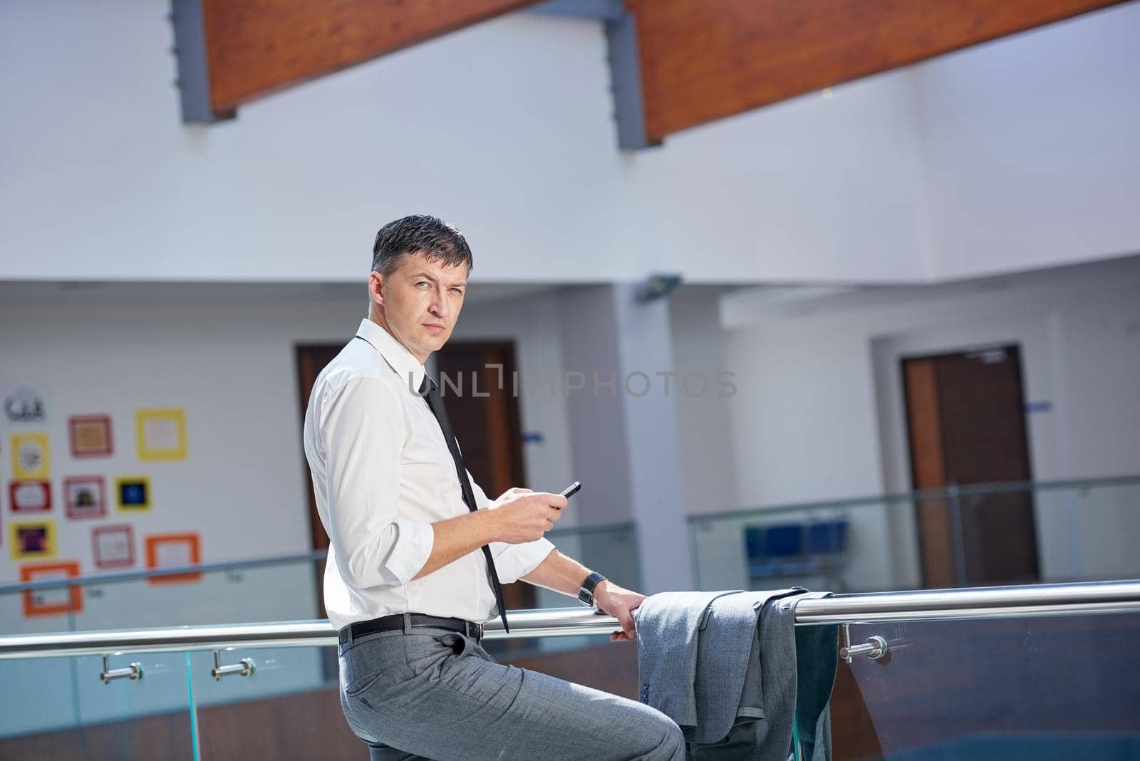 business man using phone at modern office space