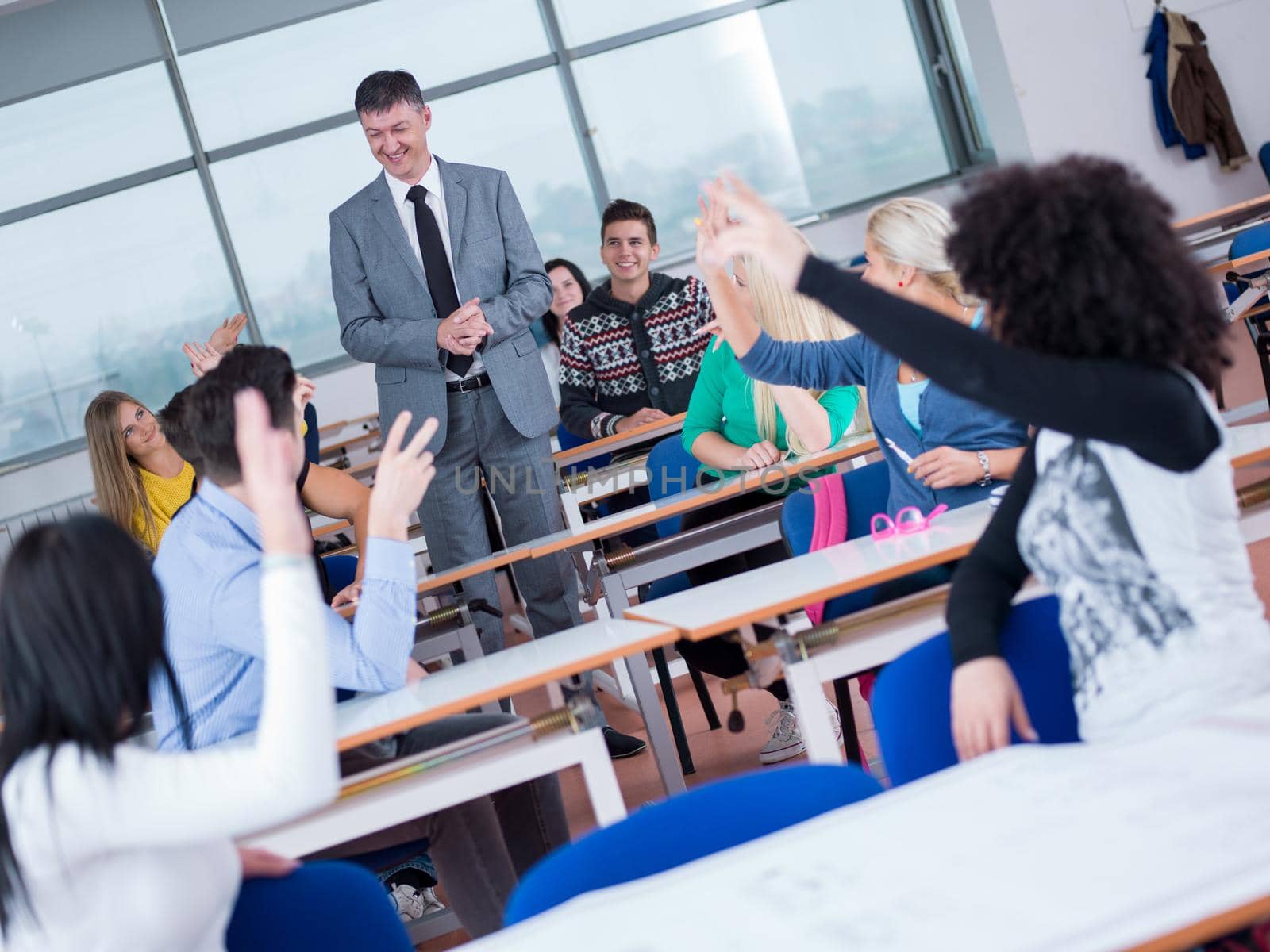 group of students with teacher in computer lab classrom learrning lessons,  get help and support