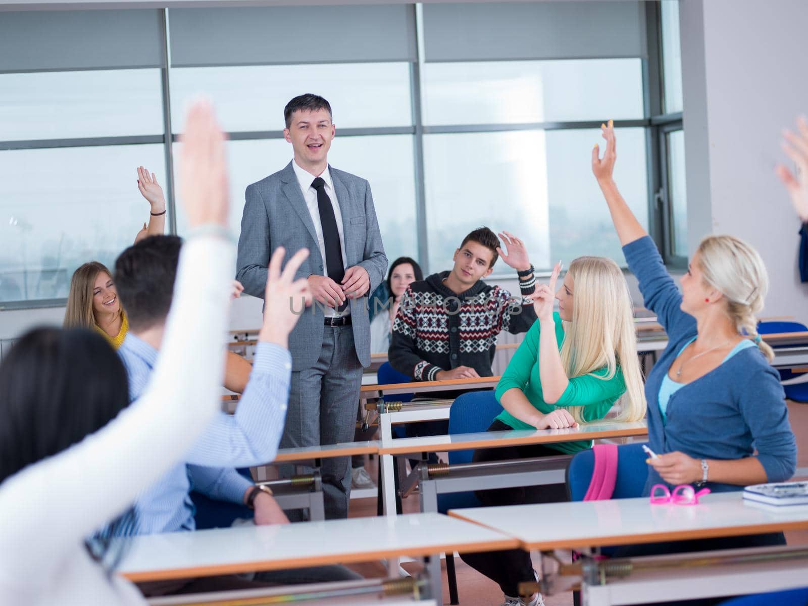 group of students with teacher in computer lab classrom learrning lessons,  get help and support