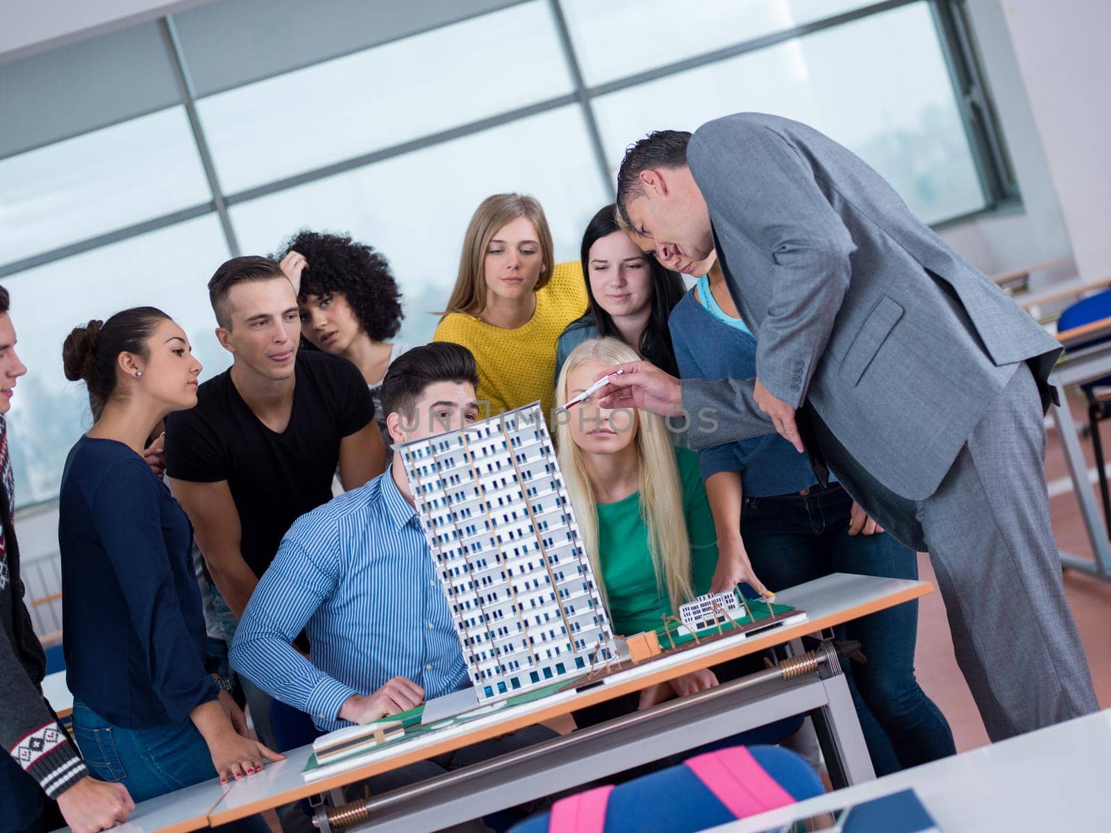 group of students with teacher in computer lab classrom learrning lessons,  get help and support