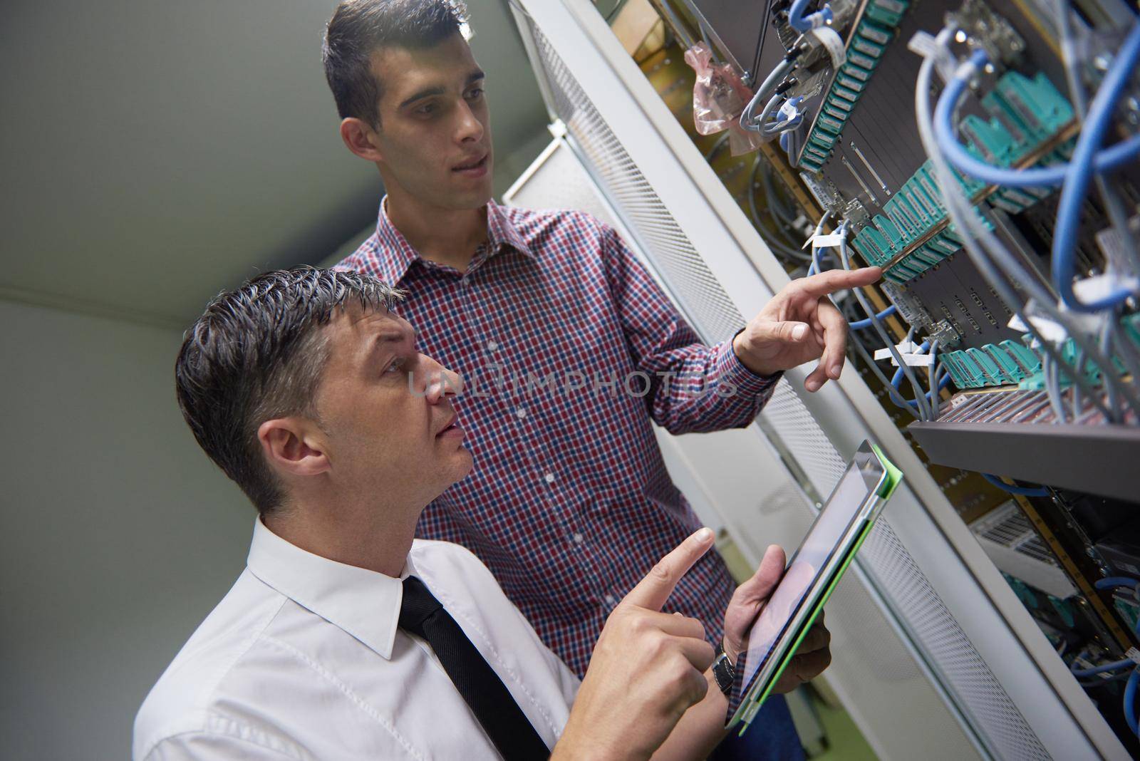 business people group working on tablet computer, network engineers in server room