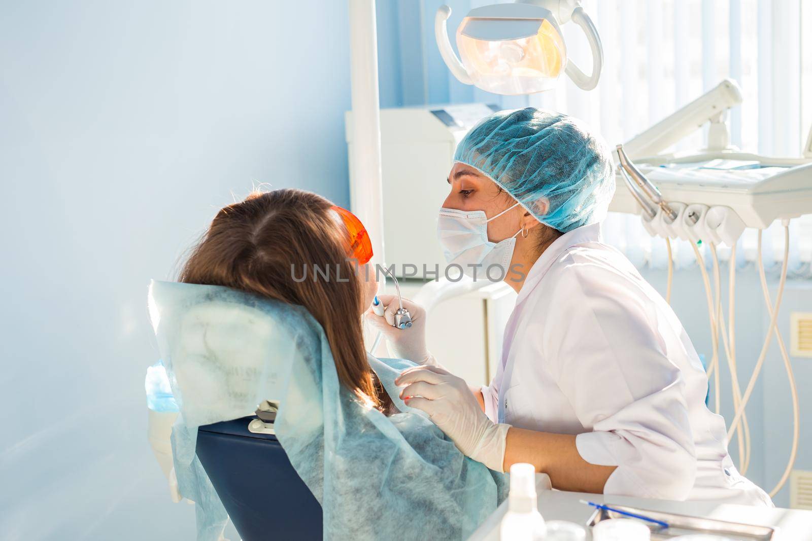 Young woman getting dental treatment. dental clinic. by Satura86
