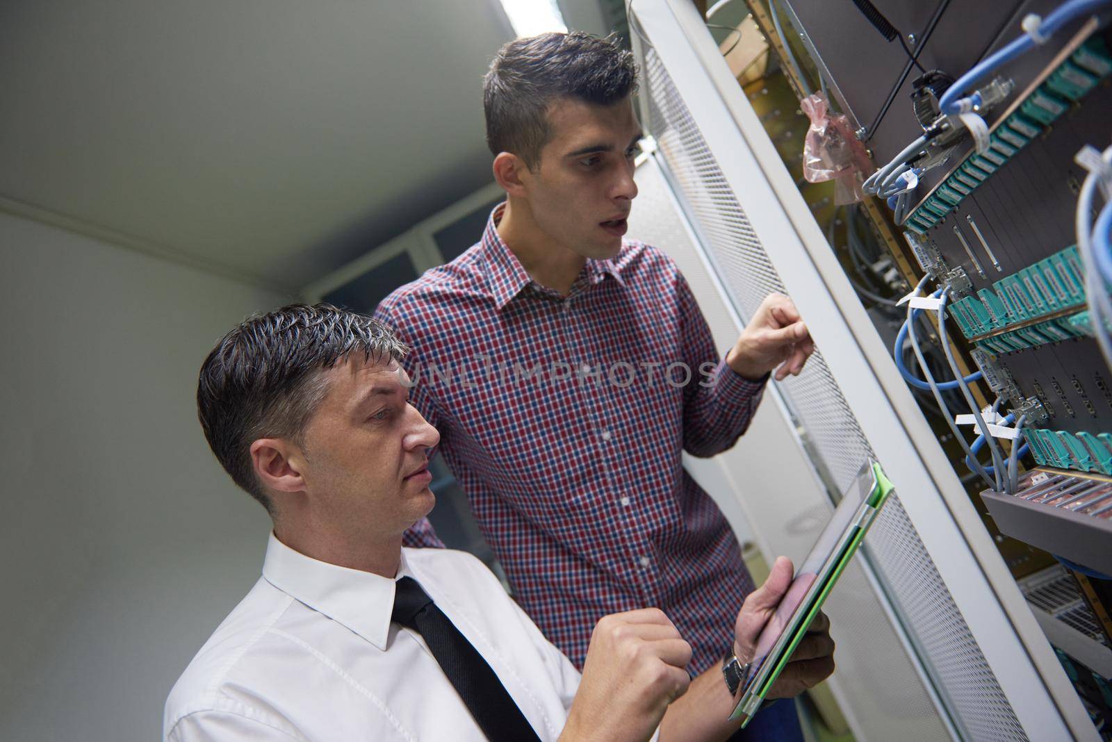 network engineers in server room by dotshock