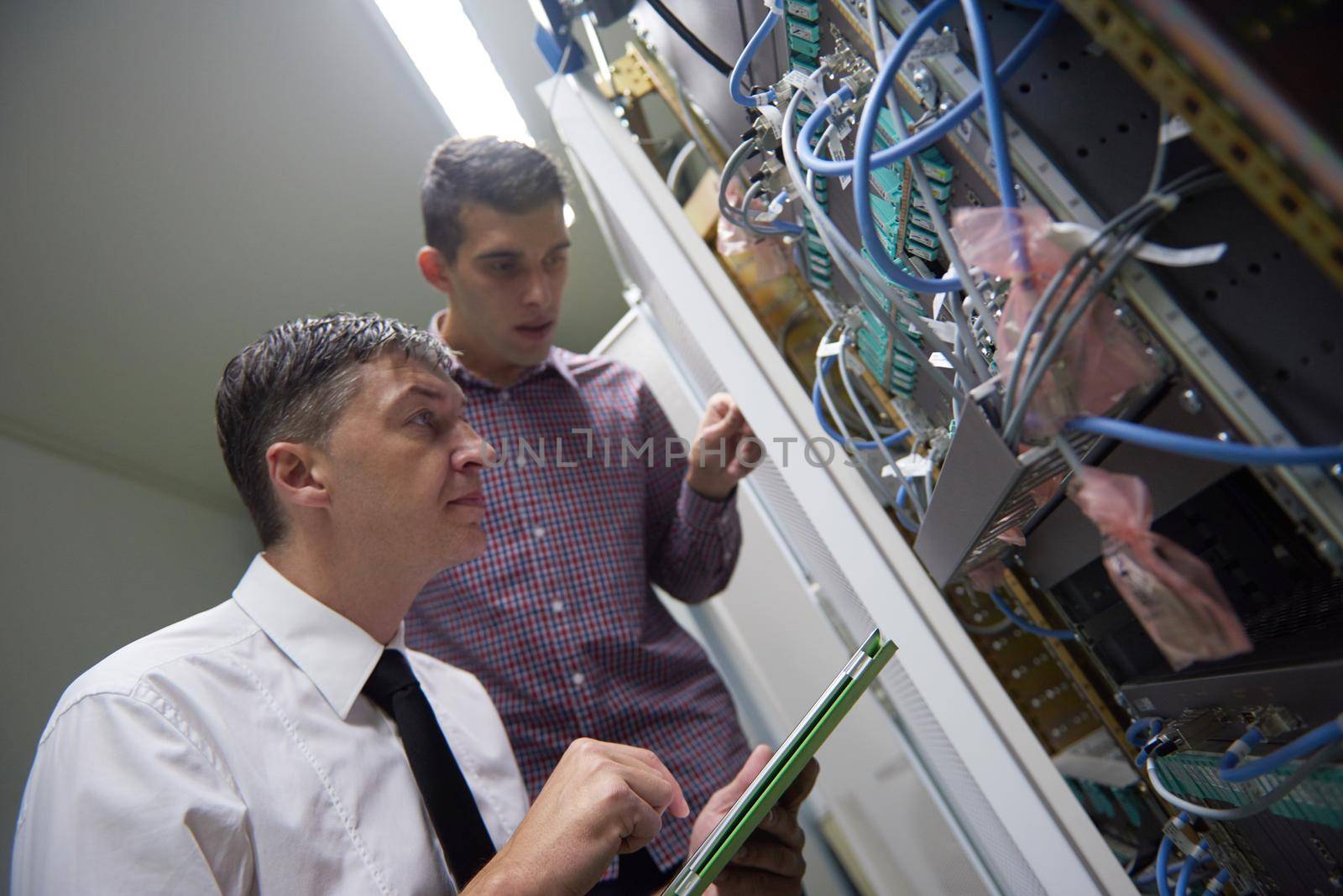 network engineers in server room by dotshock