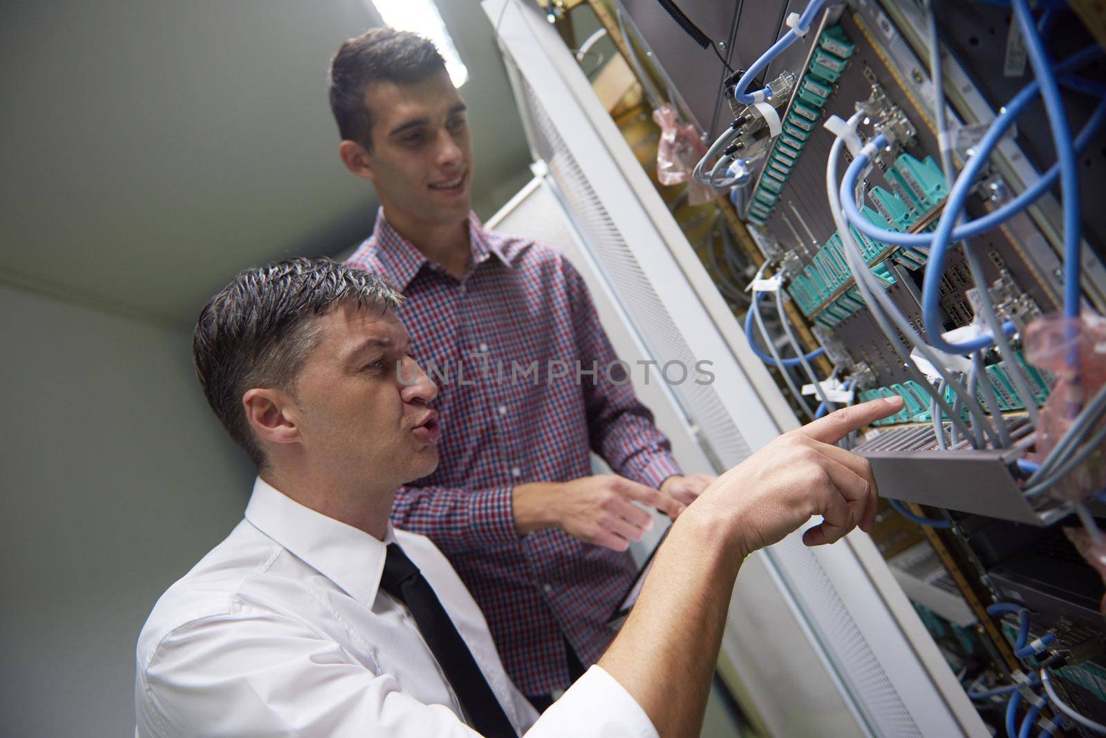 network engineers in server room by dotshock