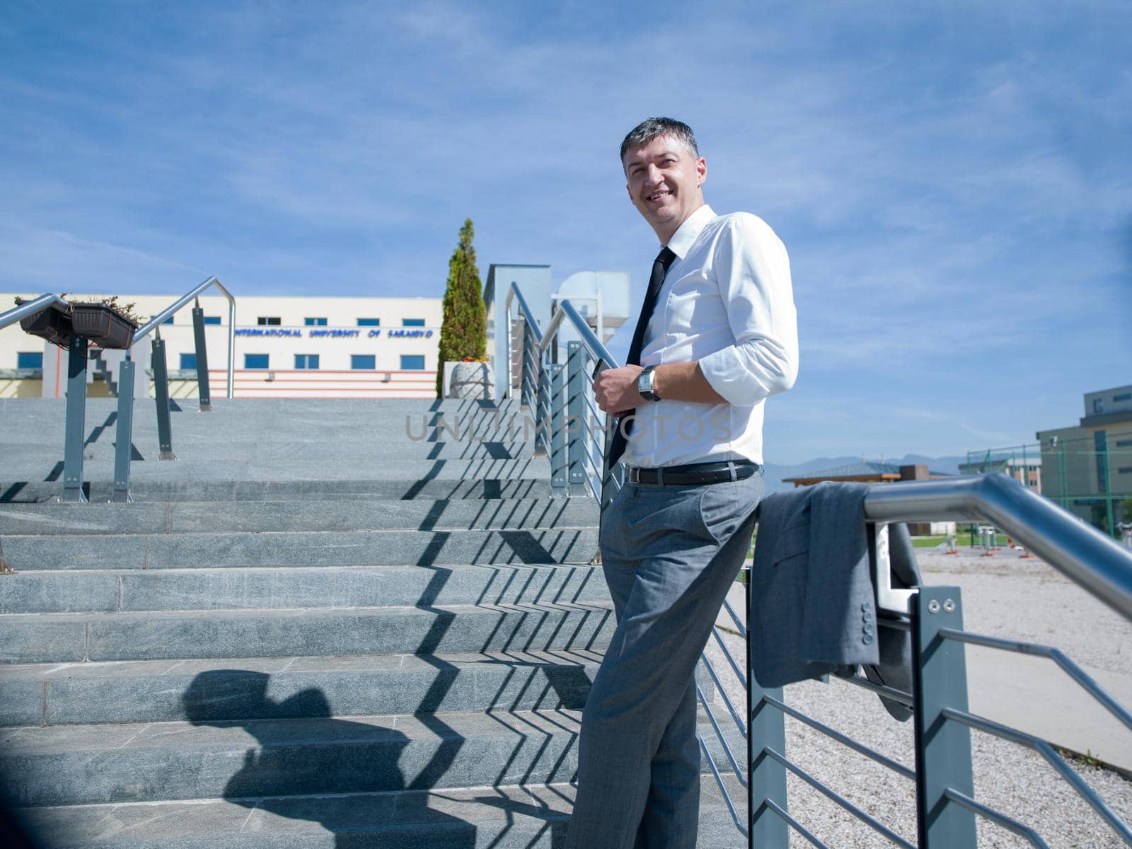 portrait of middle aged business man standing outdoor on stairs