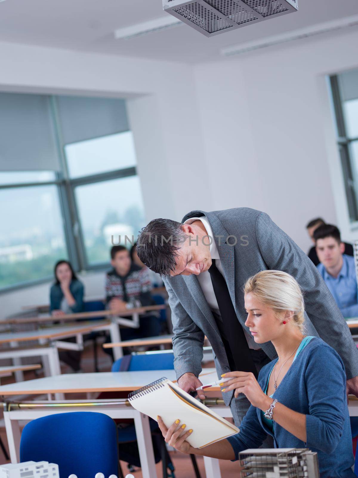 students with teacher  in computer lab classrom by dotshock