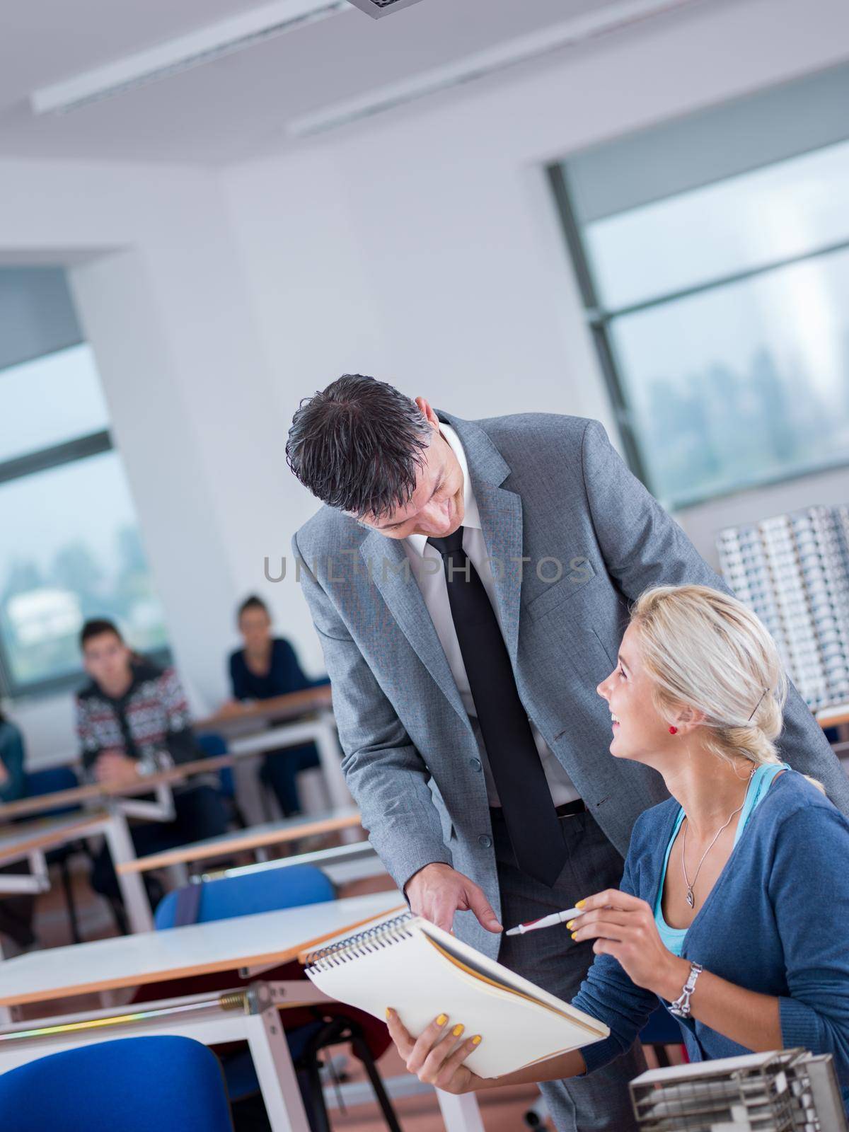 students with teacher  in computer lab classrom by dotshock