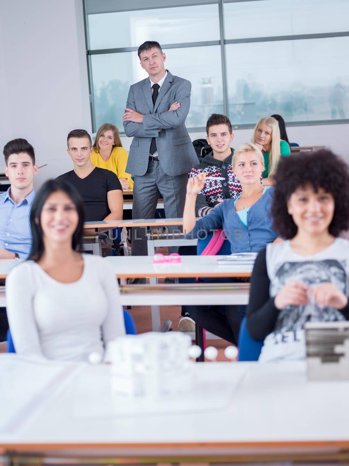 group of students with teacher in computer lab classrom learrning lessons,  get help and support