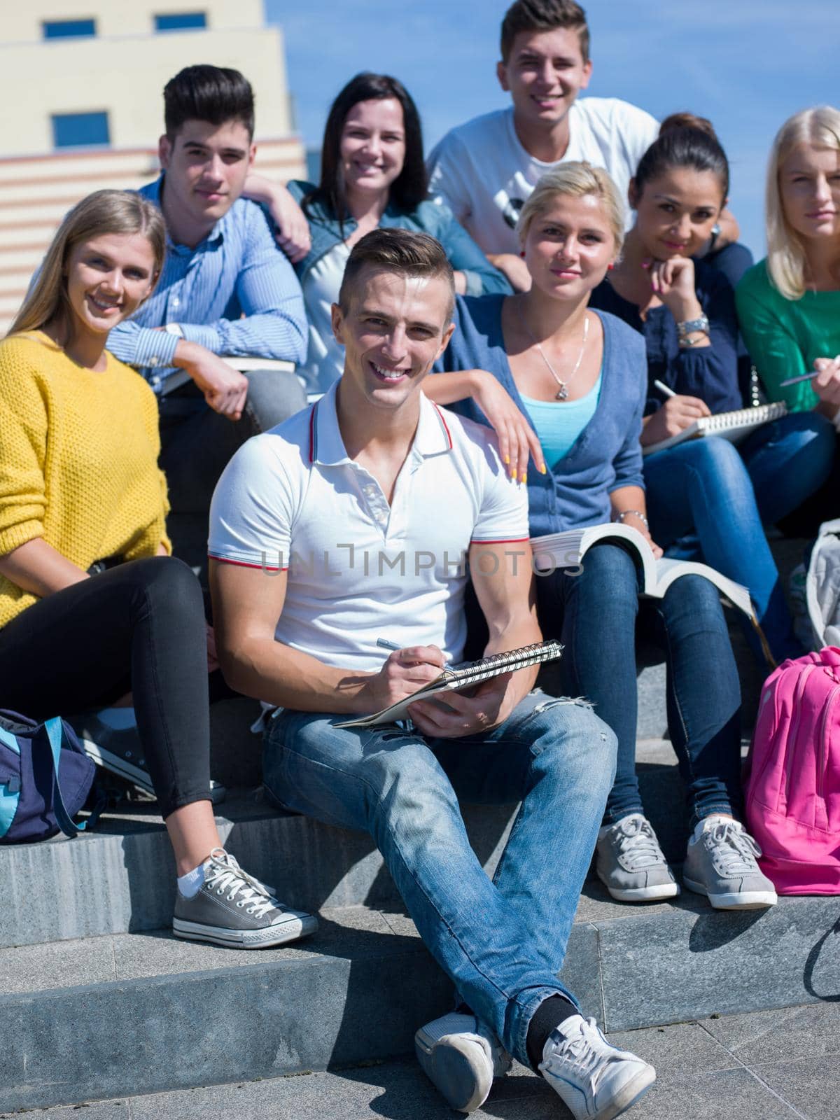 students outside sitting on steps by dotshock