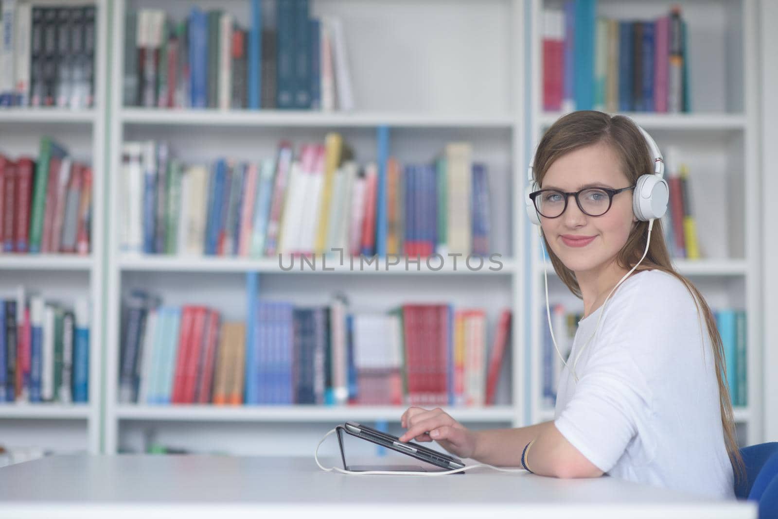 female student study in library, using tablet and searching for information’s on internet by dotshock