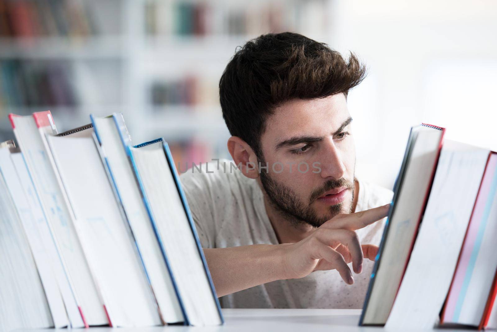 Student reading book in school library. Study lessons for exam. Hard worker and persistance concept.