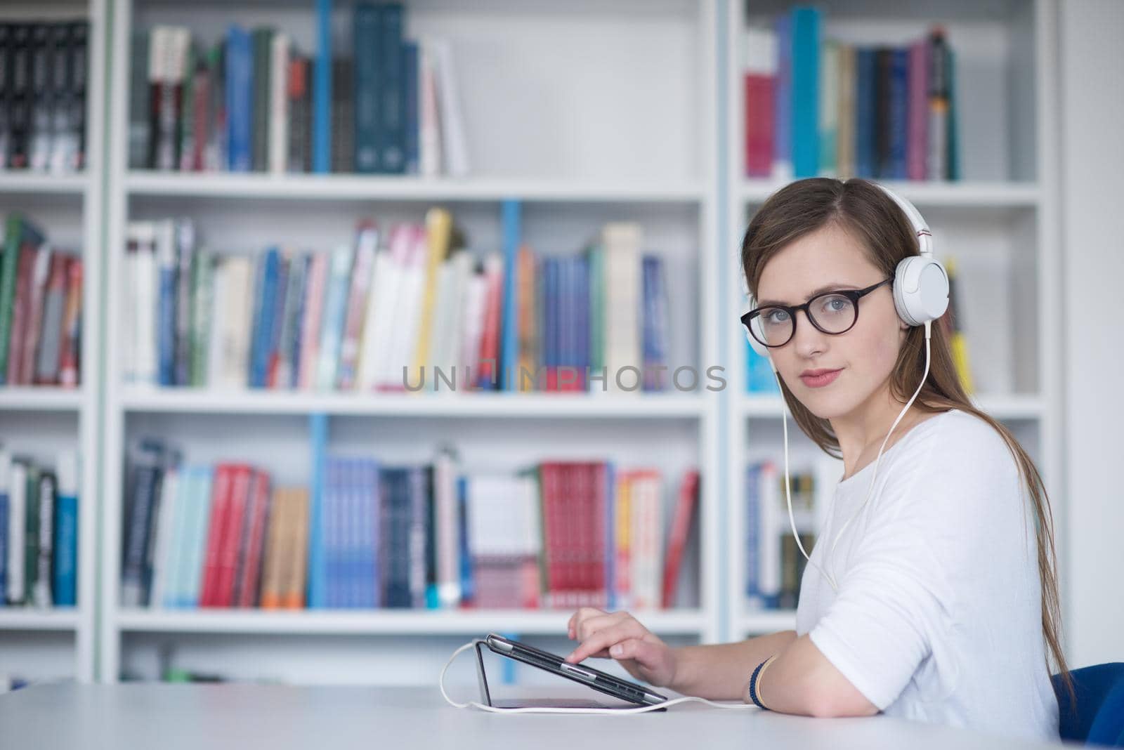 female student study in library, using tablet and searching for information’s on internet by dotshock