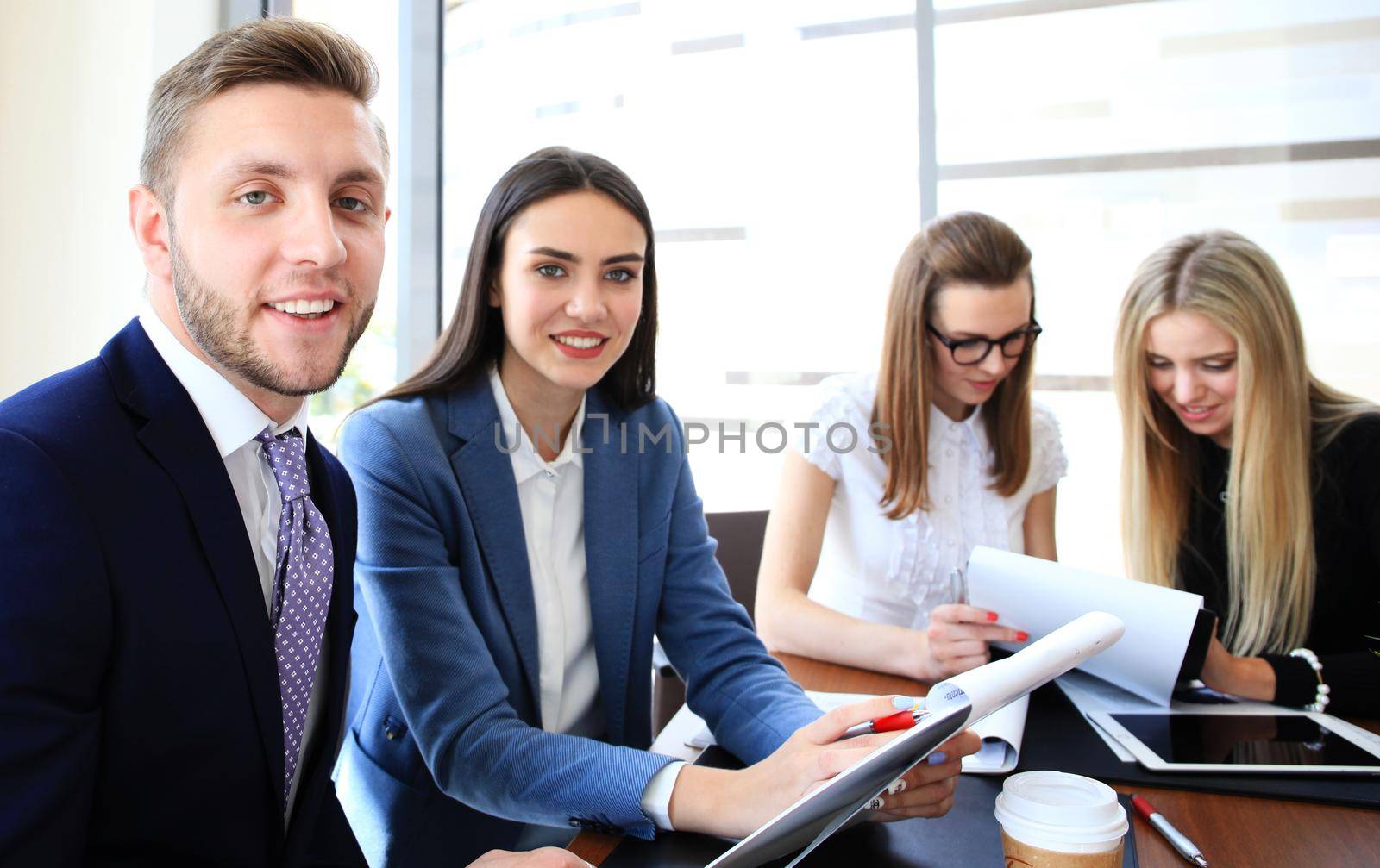 Happy smart business man with team mates discussing in the background by tsyhun