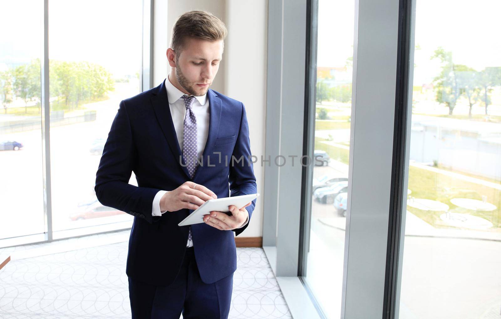 Businessman using his tablet in the office.