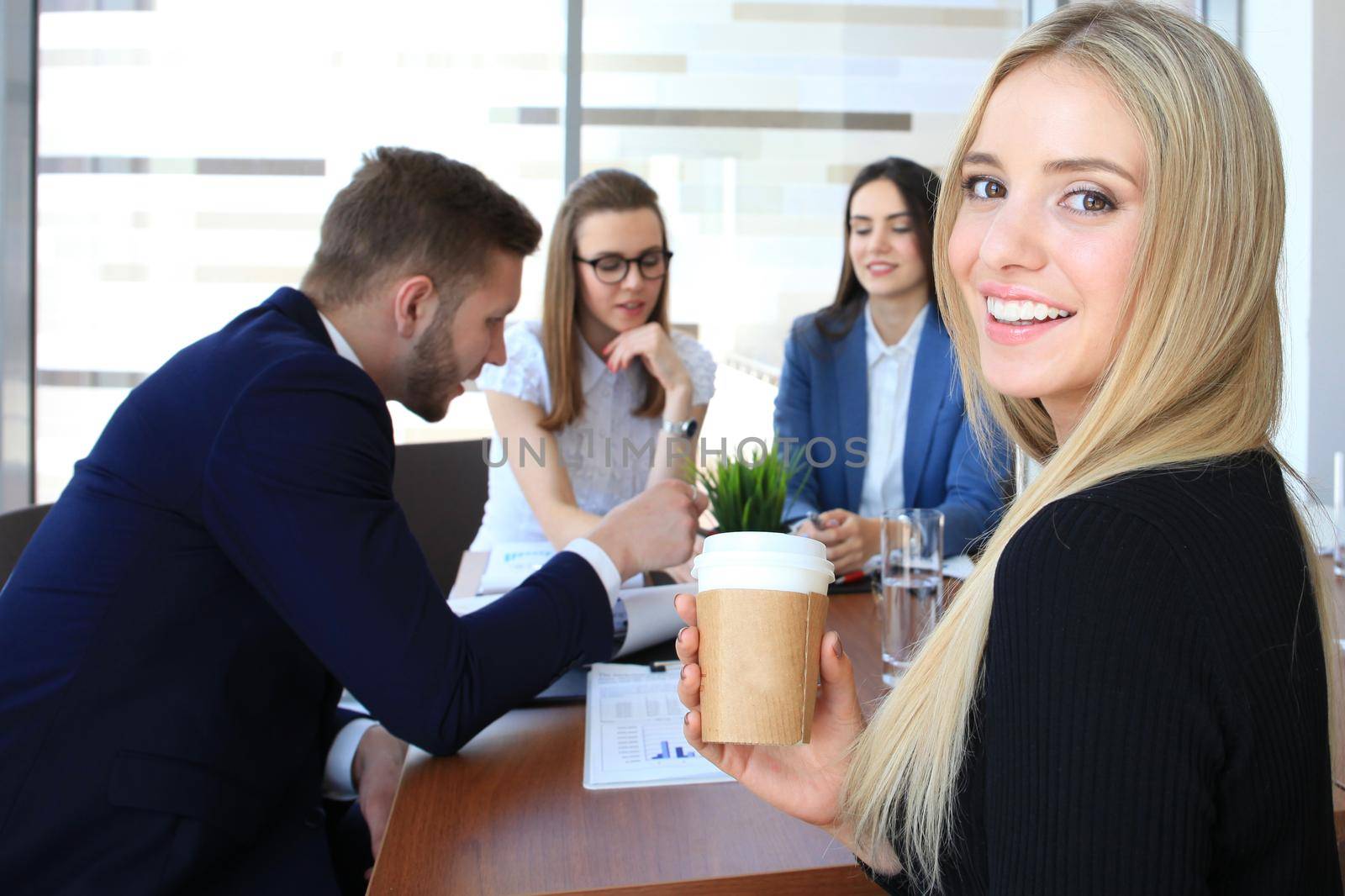 business woman with her staff, people group in background at modern bright office indoors. by tsyhun