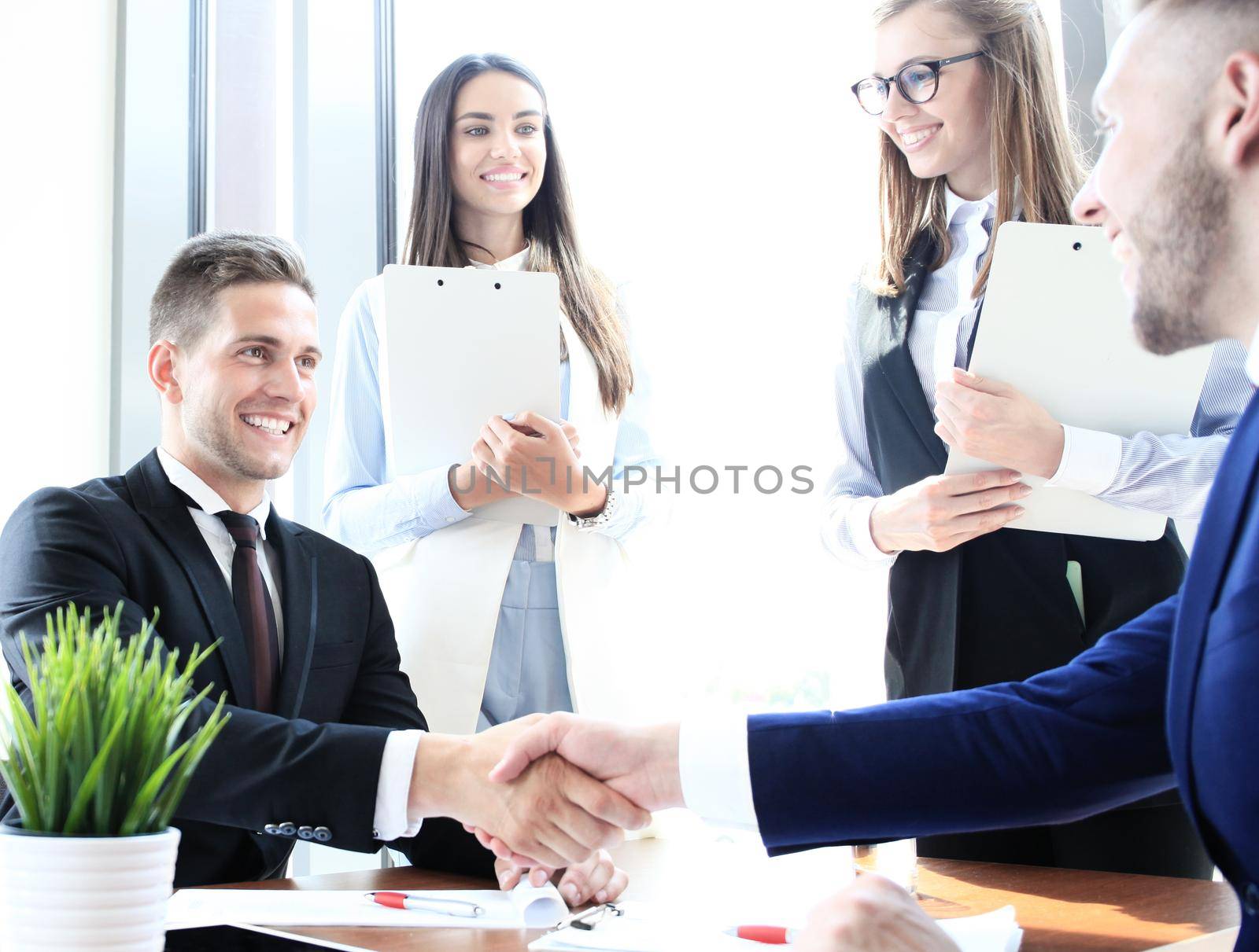 Business people shaking hands, finishing up a meeting by tsyhun