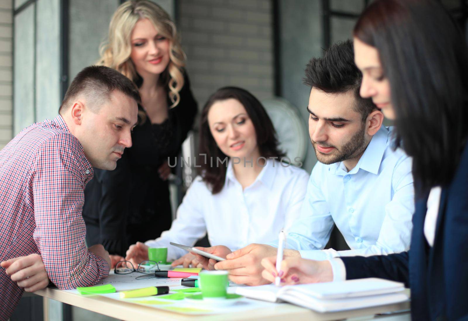 Young businesspeople working together in the office. by tsyhun