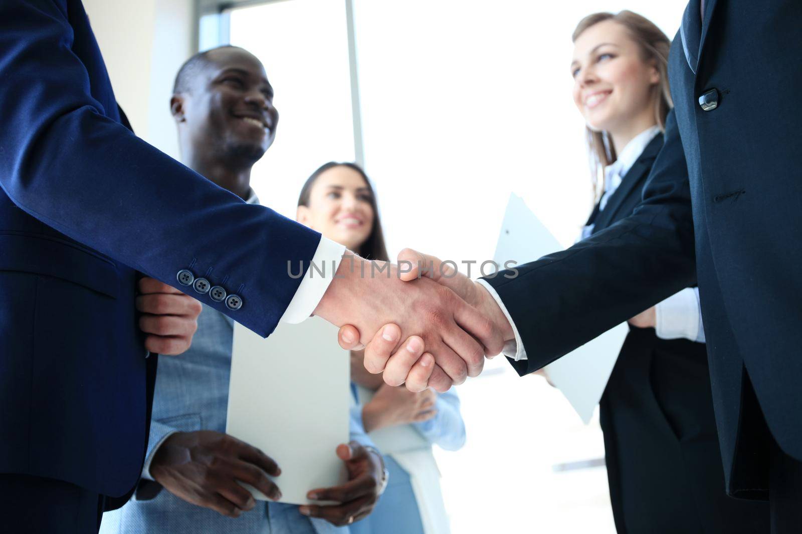 Business people shaking hands, finishing up a meeting by tsyhun