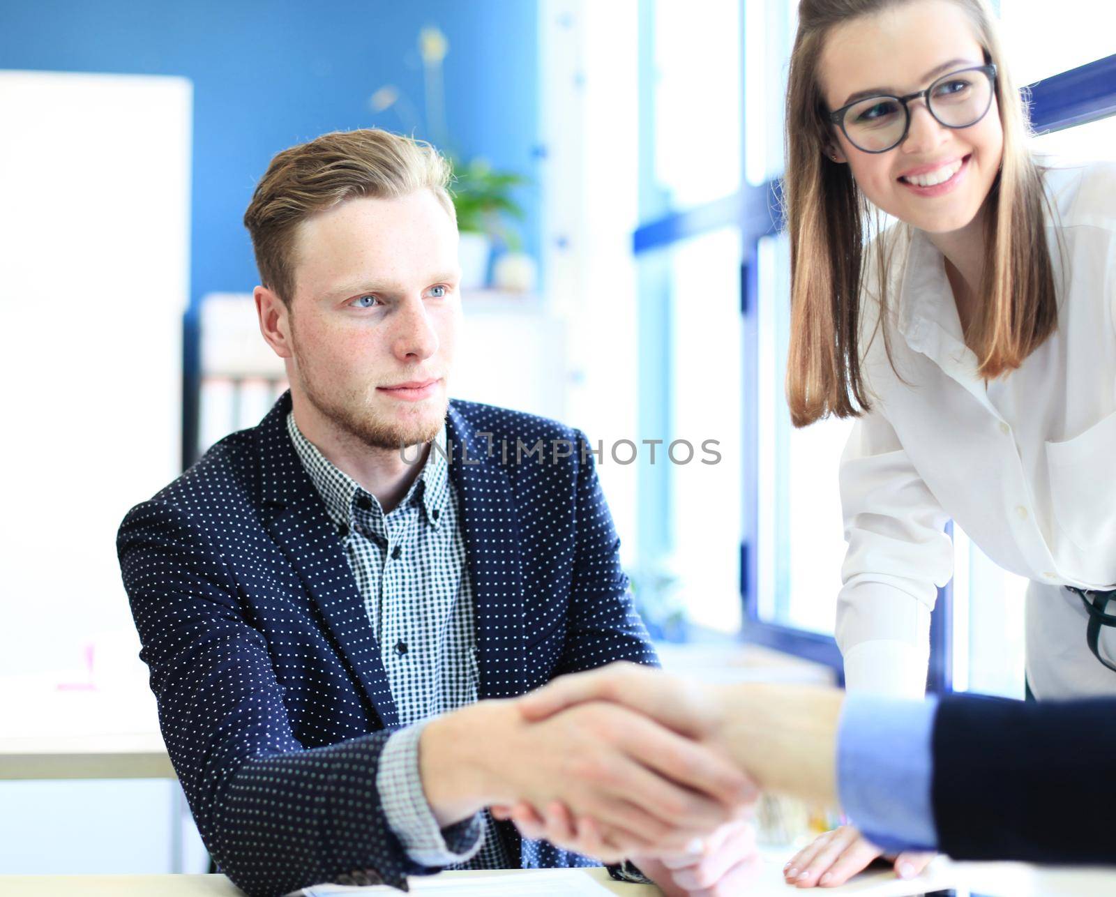 Business people shaking hands, finishing up a meeting by tsyhun