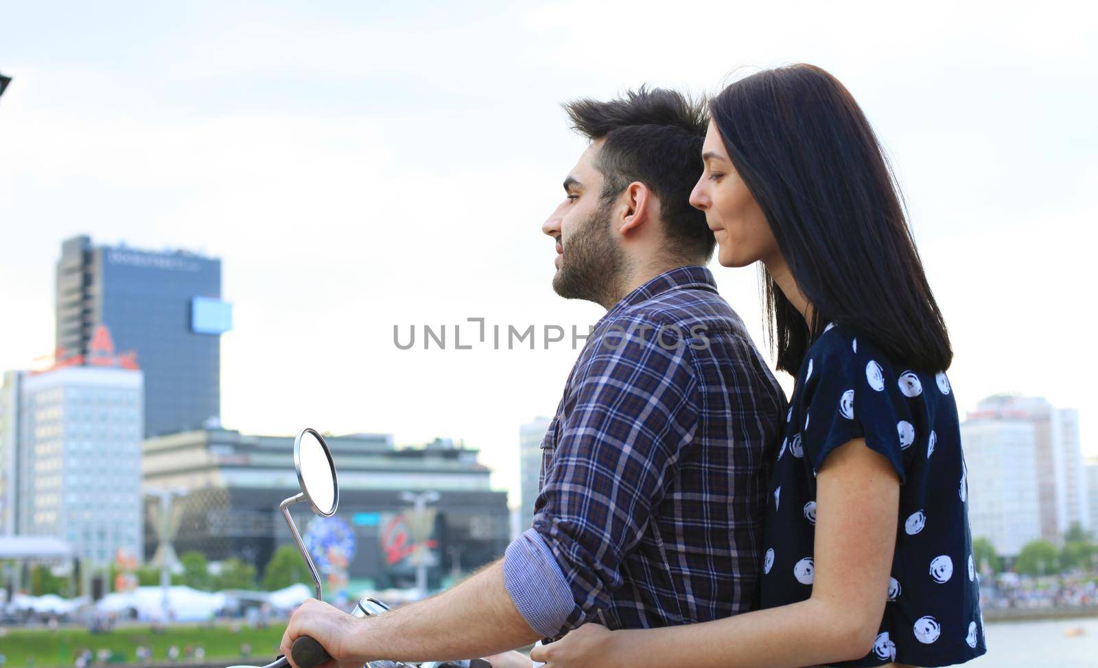 Young beautiful couple riding on motorbike. Adventure and vacations concept.