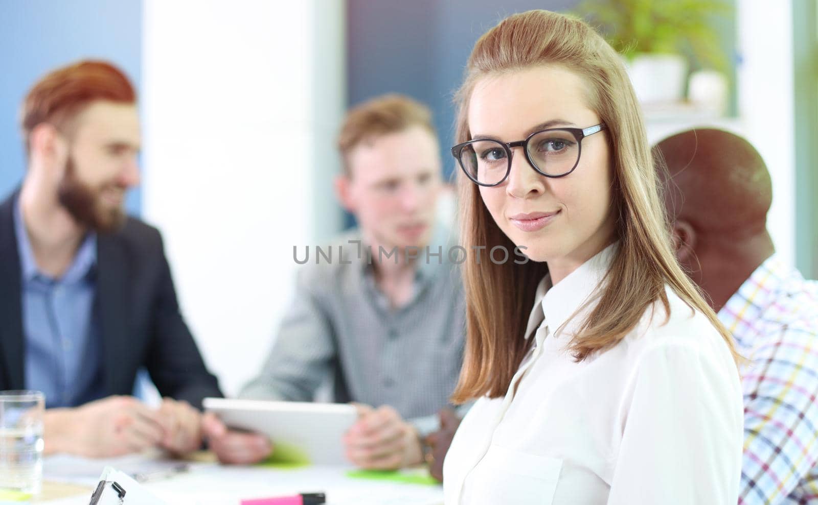 business woman with her staff, people group in background at modern bright office indoors