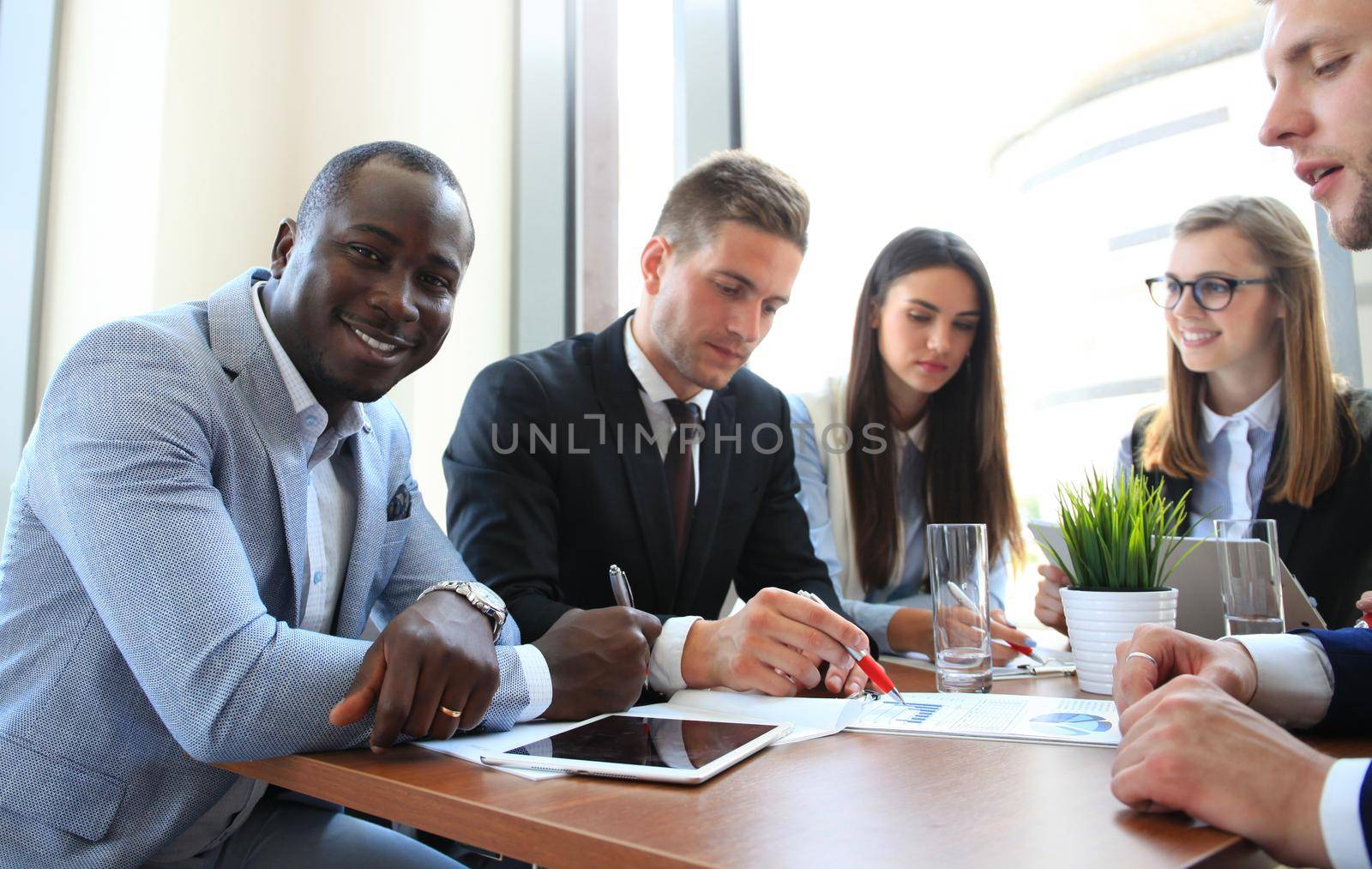 Business team discussing together business plans in office