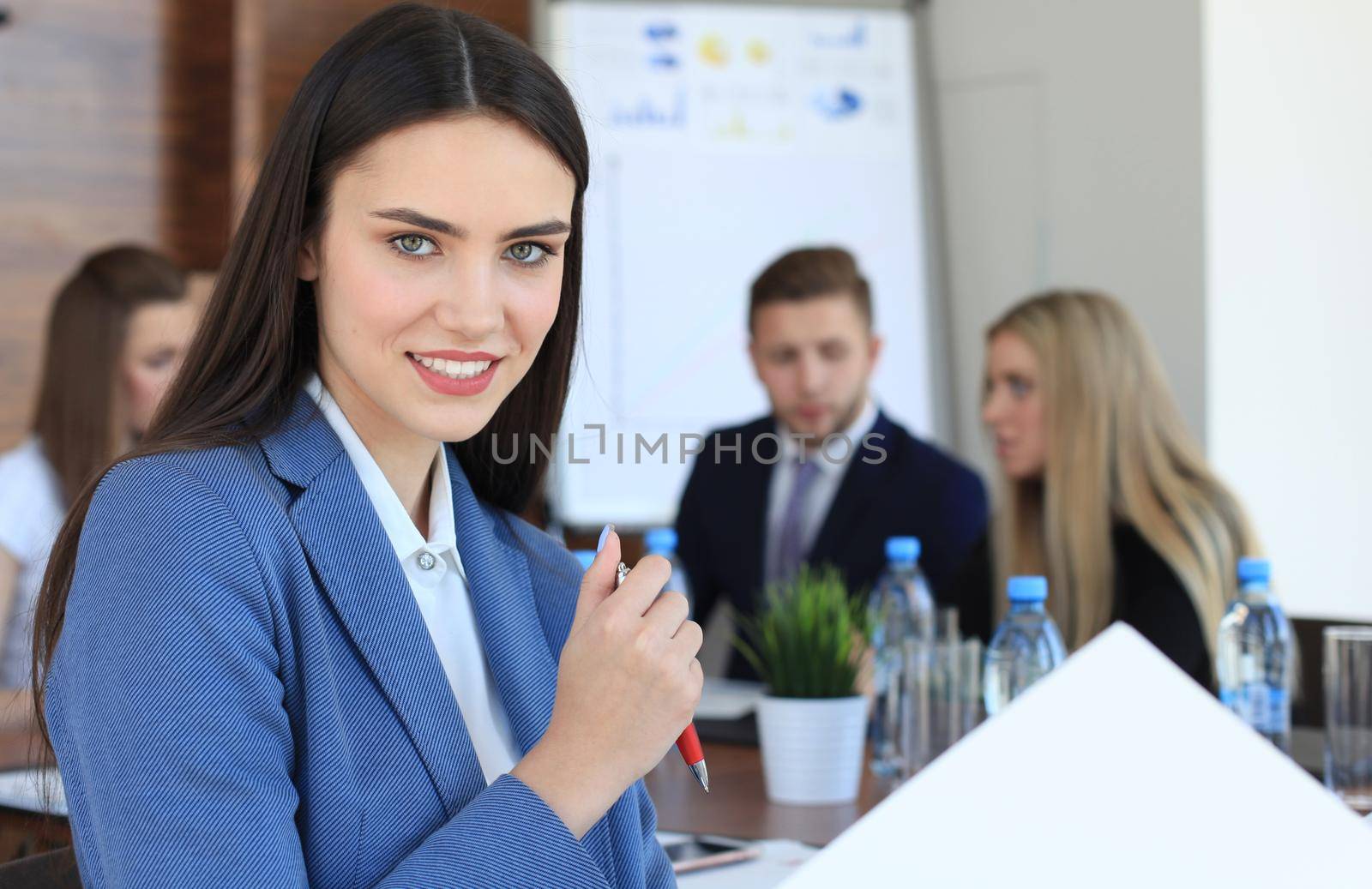 business woman with her staff, people group in background at modern bright office indoors.