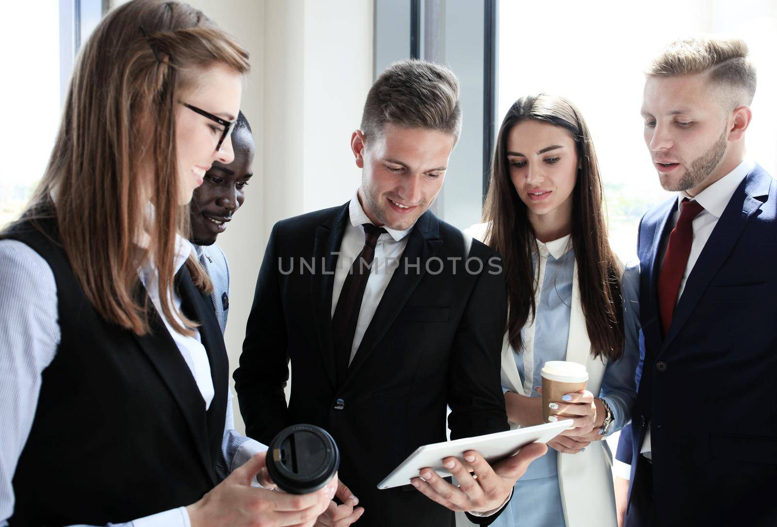 Group of buisness people working on tablet by tsyhun