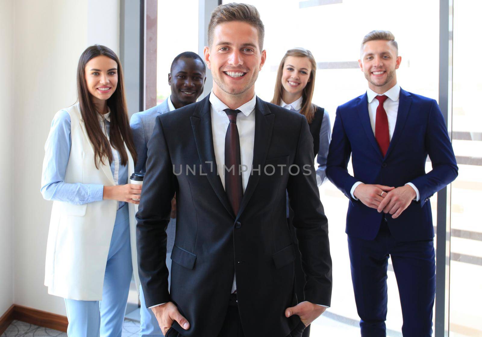 Happy smart business man with team mates discussing in the background by tsyhun