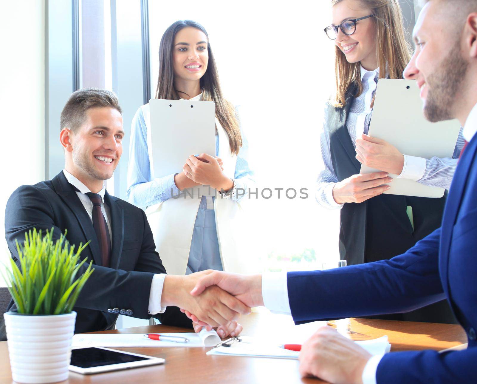 Business people shaking hands, finishing up a meeting by tsyhun