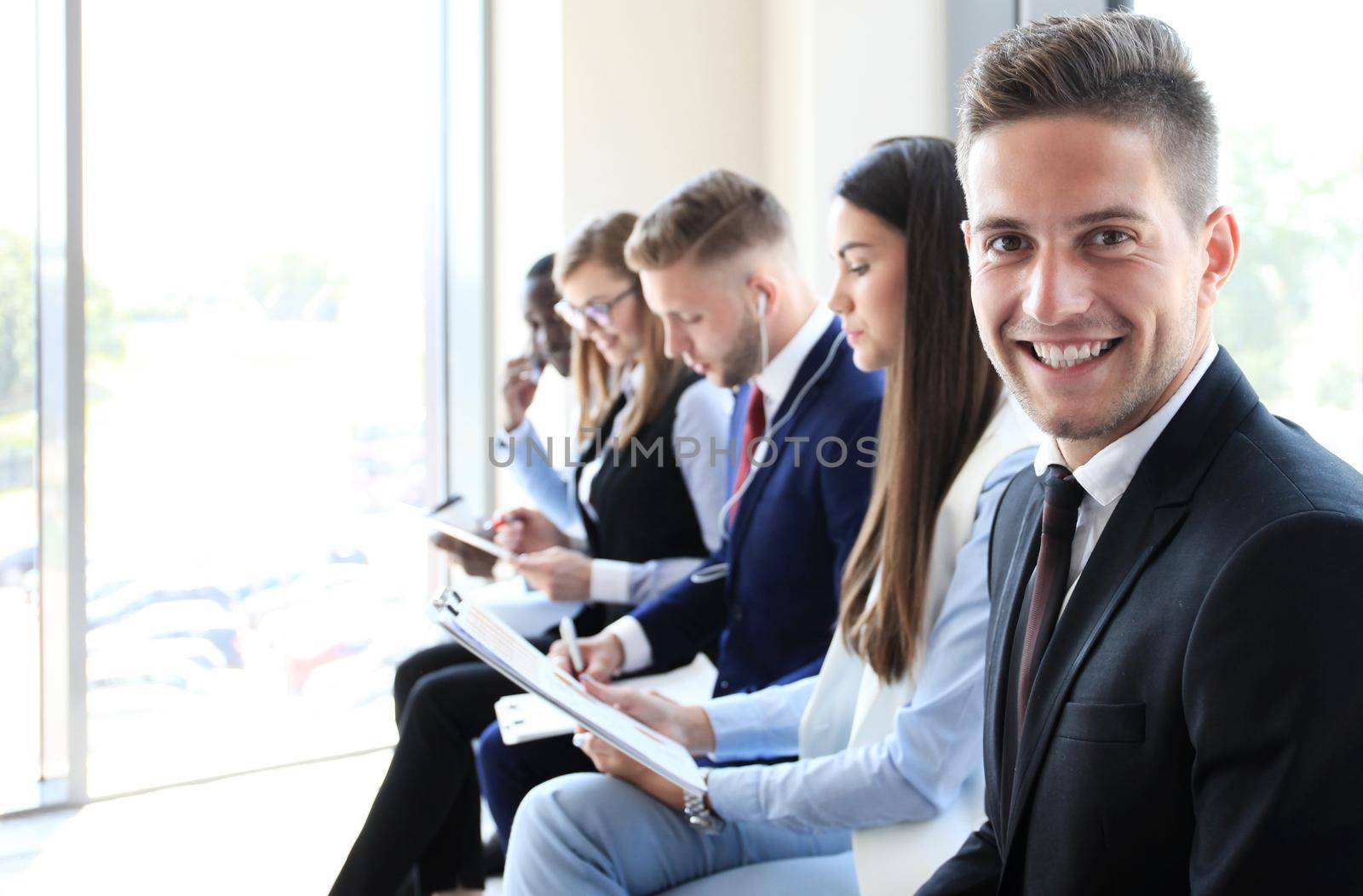 Businessman with colleagues in the background in office