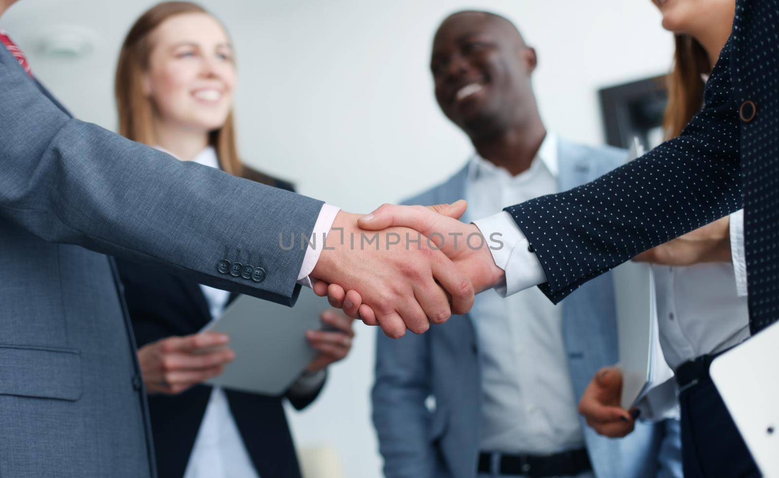 Business people shaking hands, finishing up a meeting by tsyhun