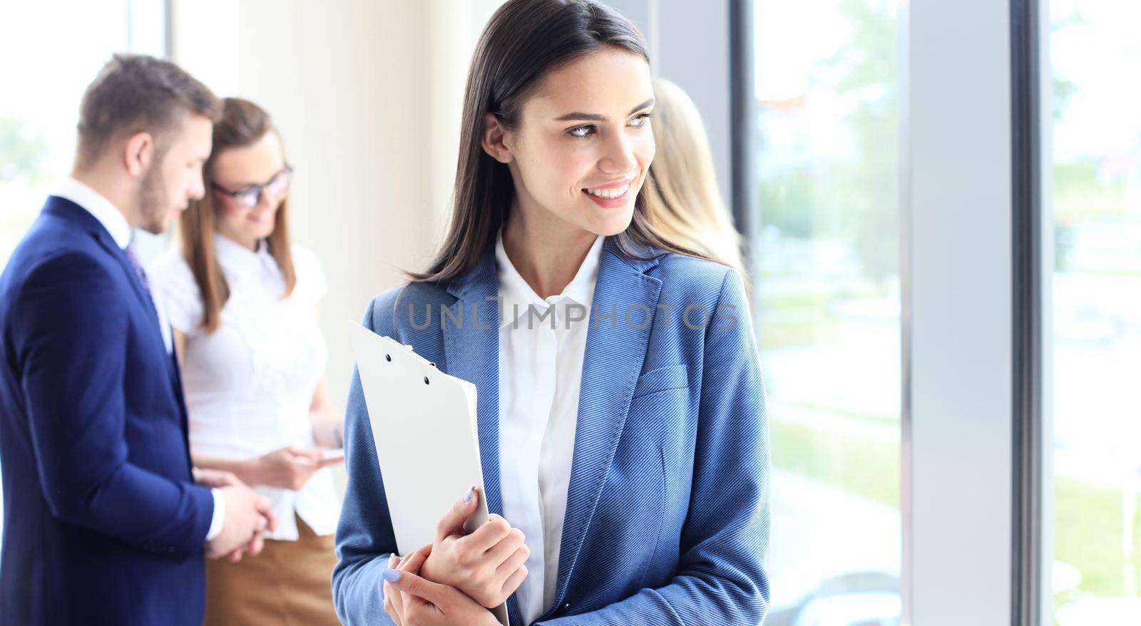 Face of beautiful woman on the background of business people by tsyhun