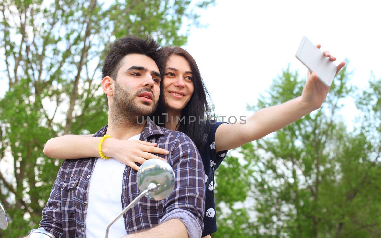 Young beautiful couple riding on motorbike. Adventure and vacations concept.