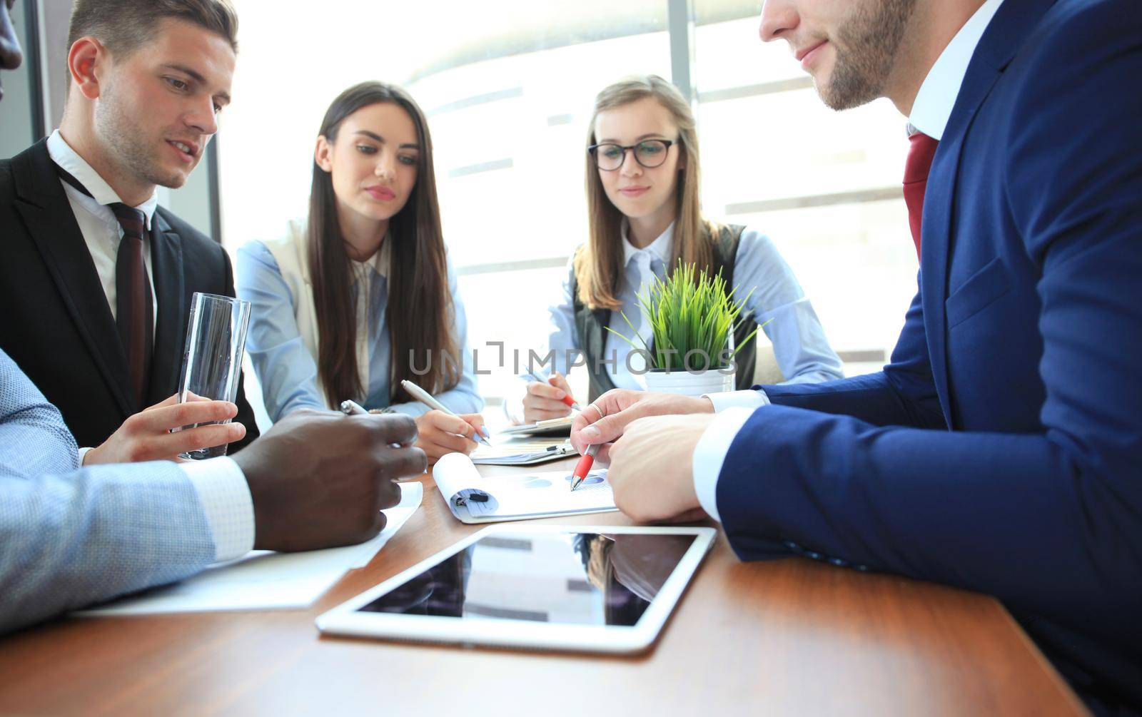 group of business people at a meeting on the background of office by tsyhun