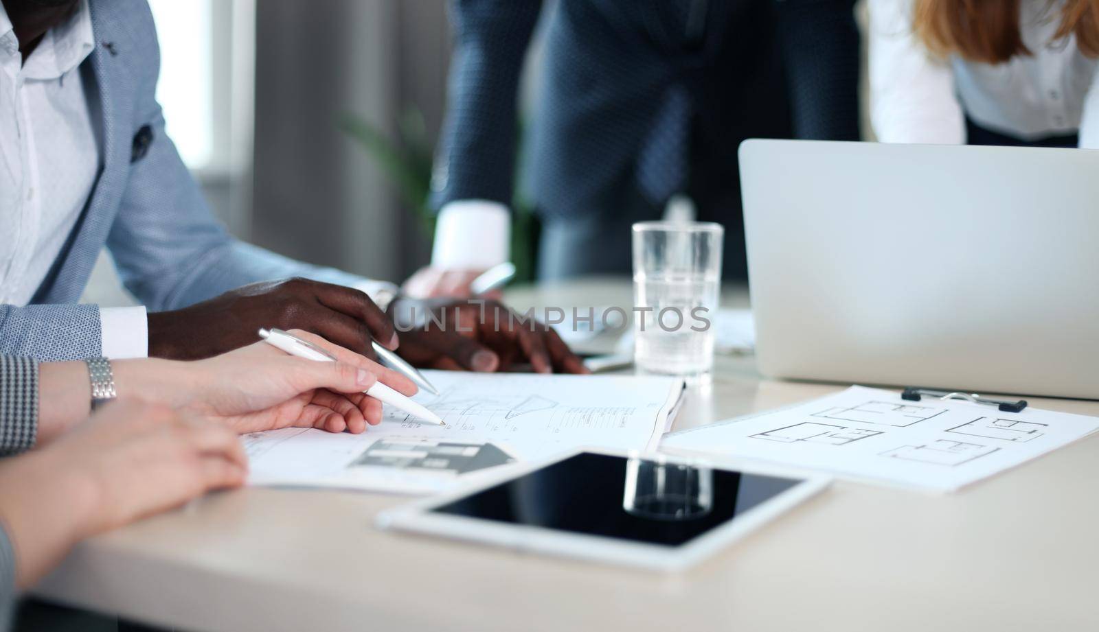 Real-estate agent showing house plans on electronic tablet