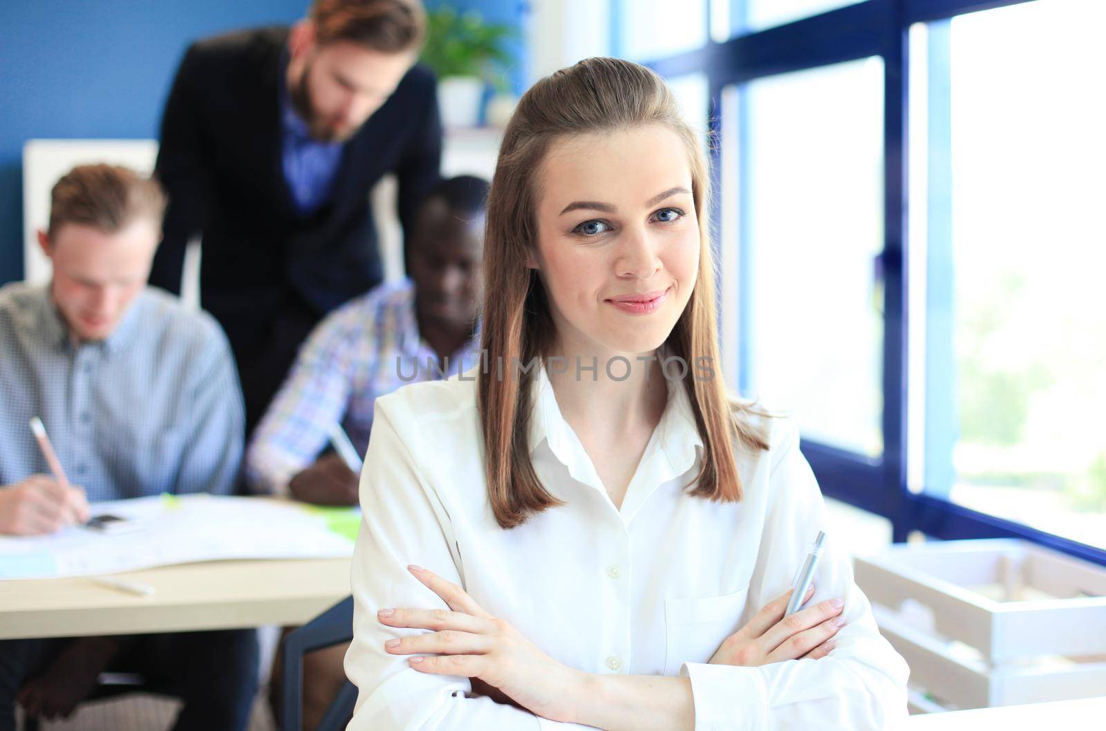 business woman with her staff, people group in background at modern bright office indoors