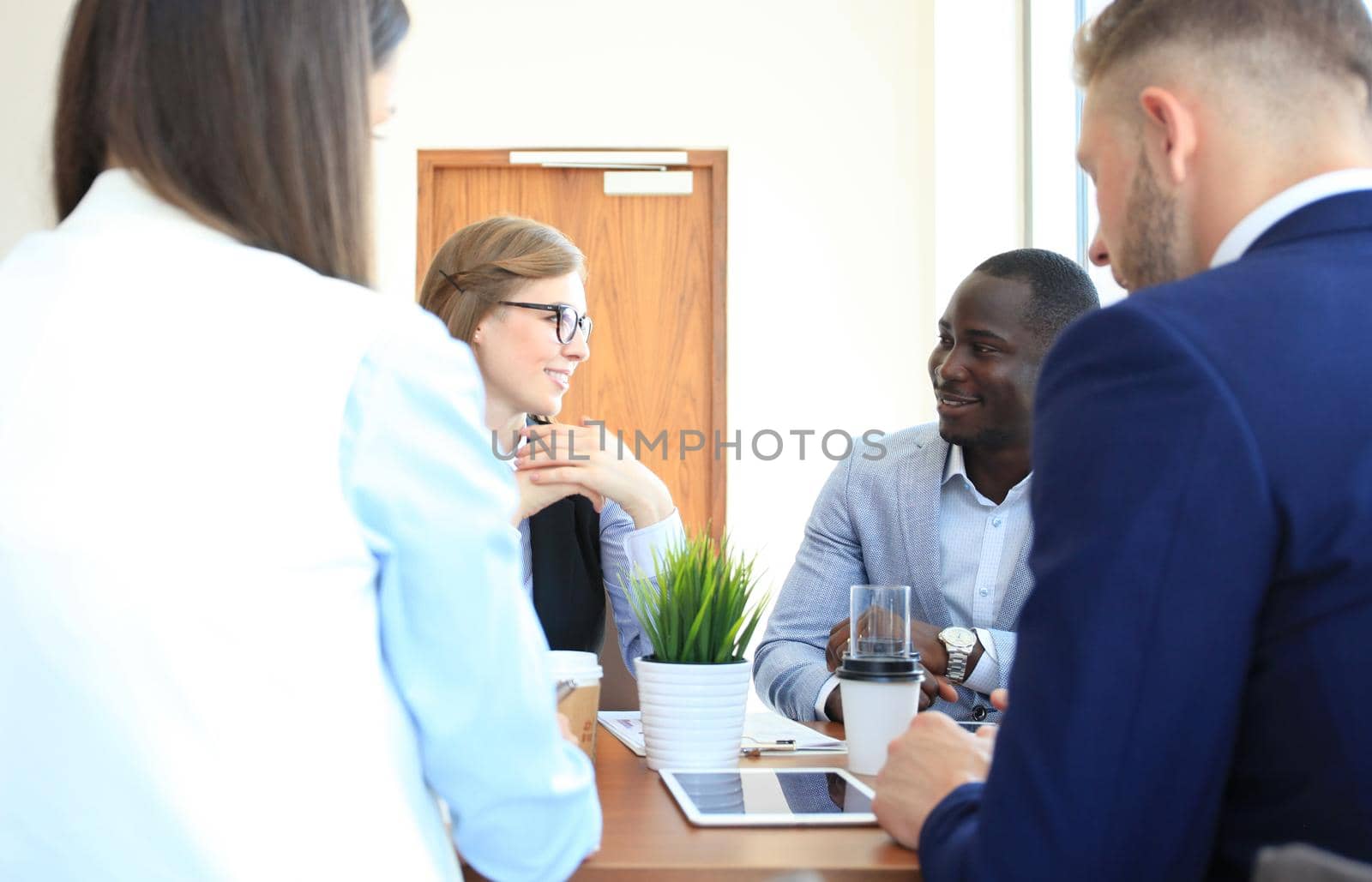 Portrait of smart business partners planning work at meeting by tsyhun