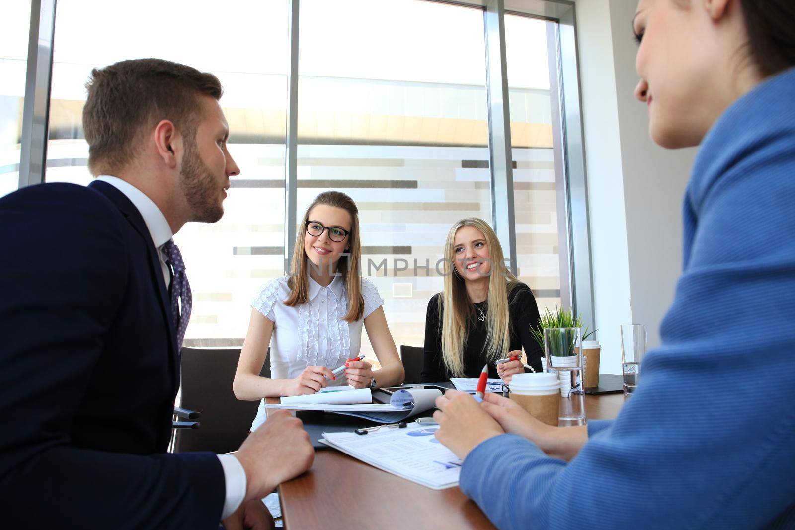 Business people working on new project at modern office by tsyhun