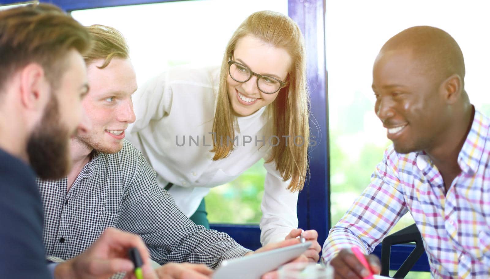 Image of business partners discussing documents and ideas at meeting by tsyhun