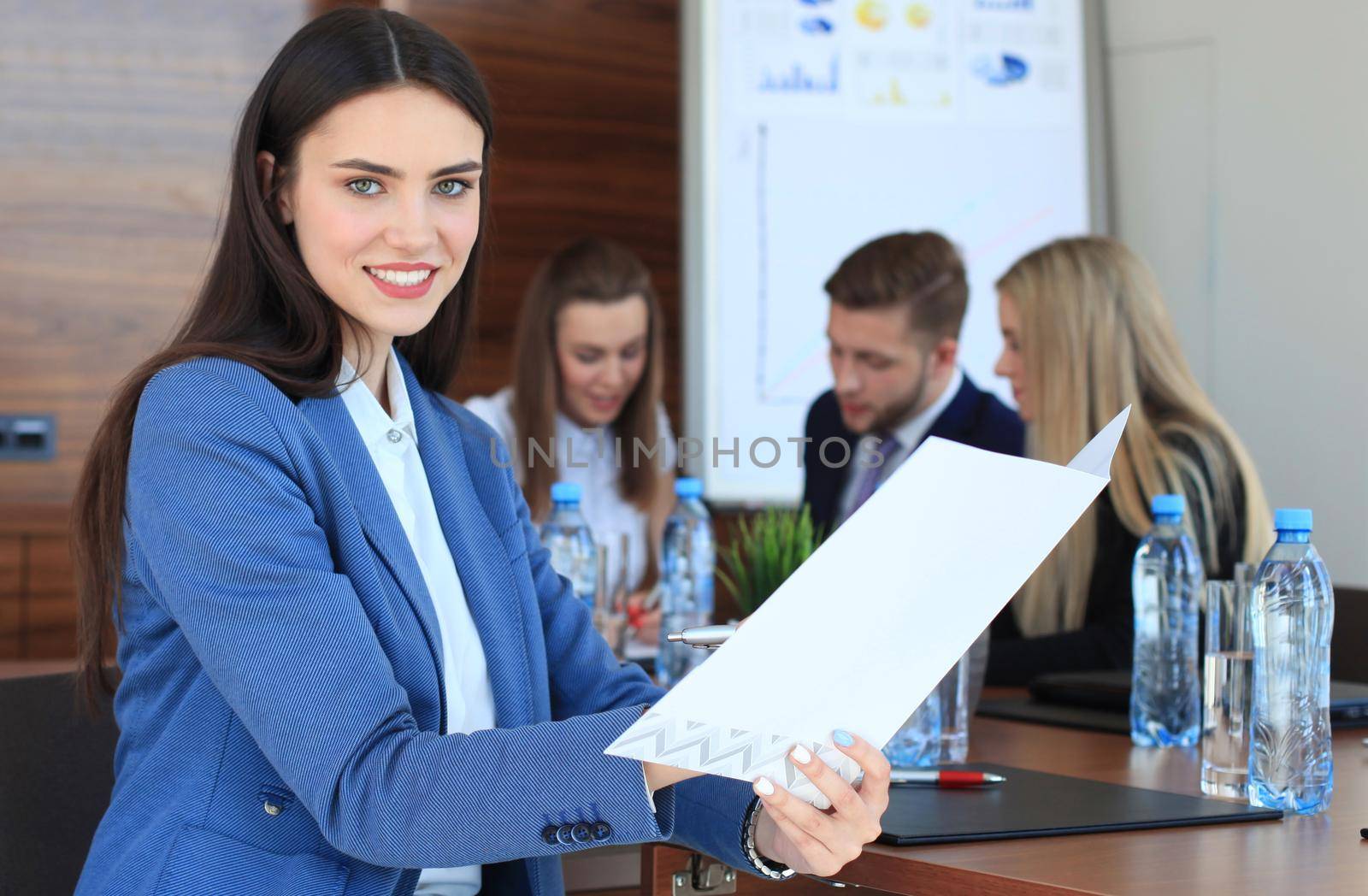 business woman with her staff, people group in background at modern bright office indoors.