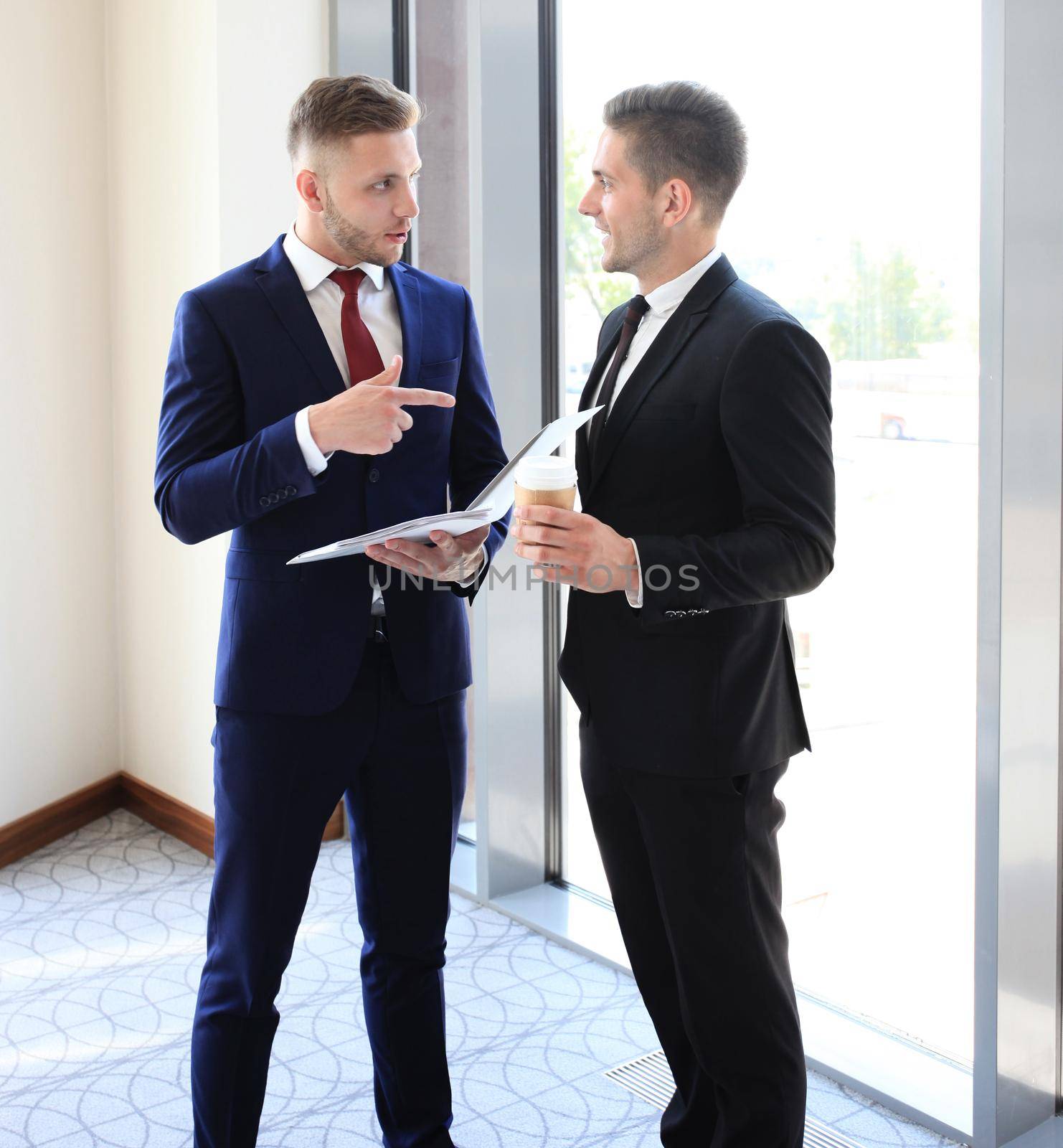 Young manager listening to his colleague explanations