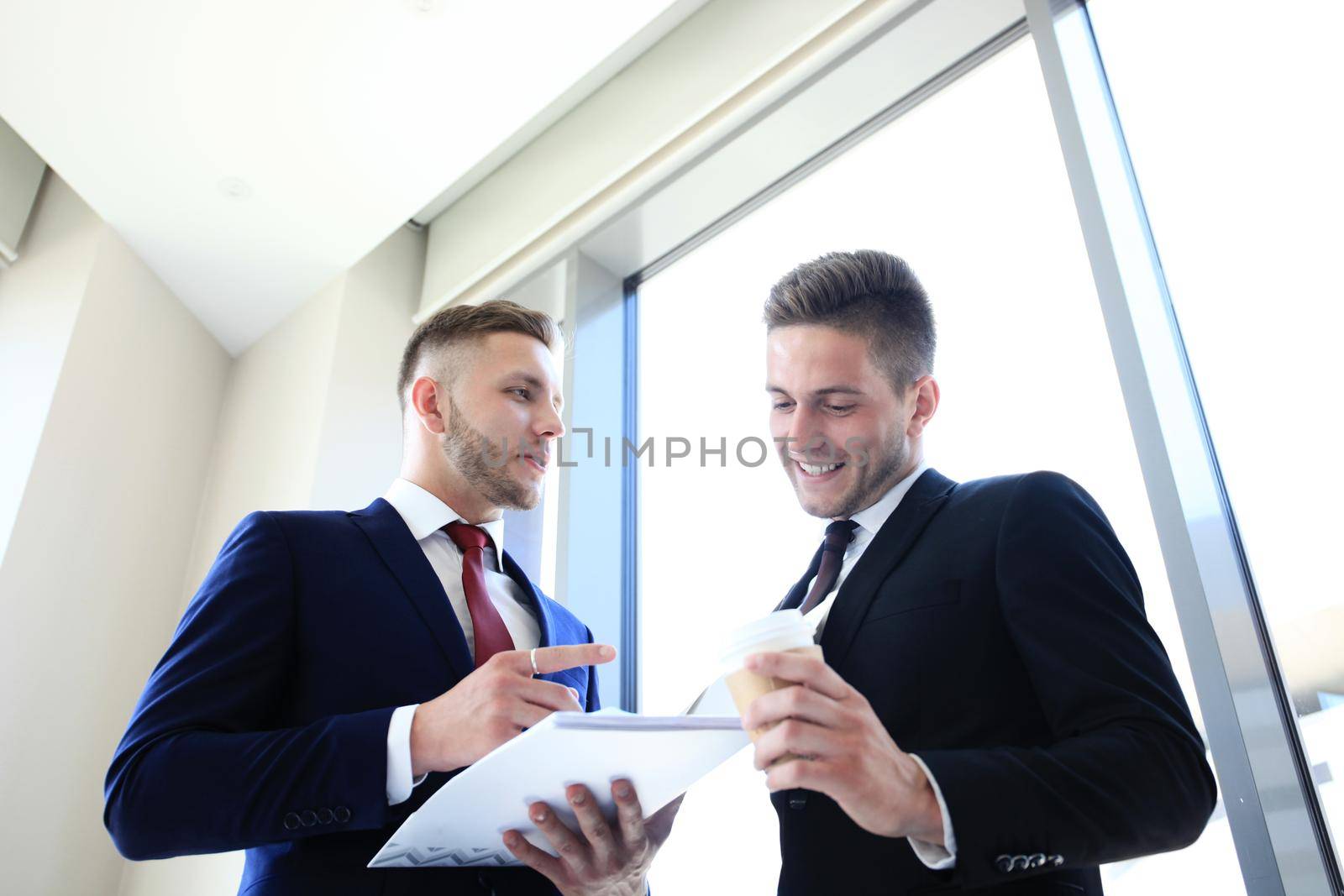 Young manager listening to his colleague explanations by tsyhun