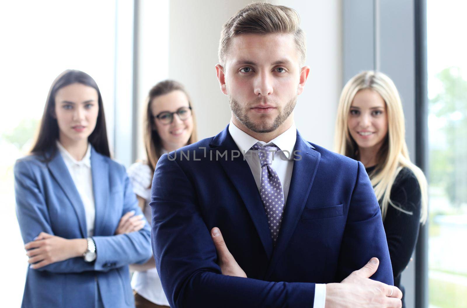 Portrait of an handsome businessman in front of his team
