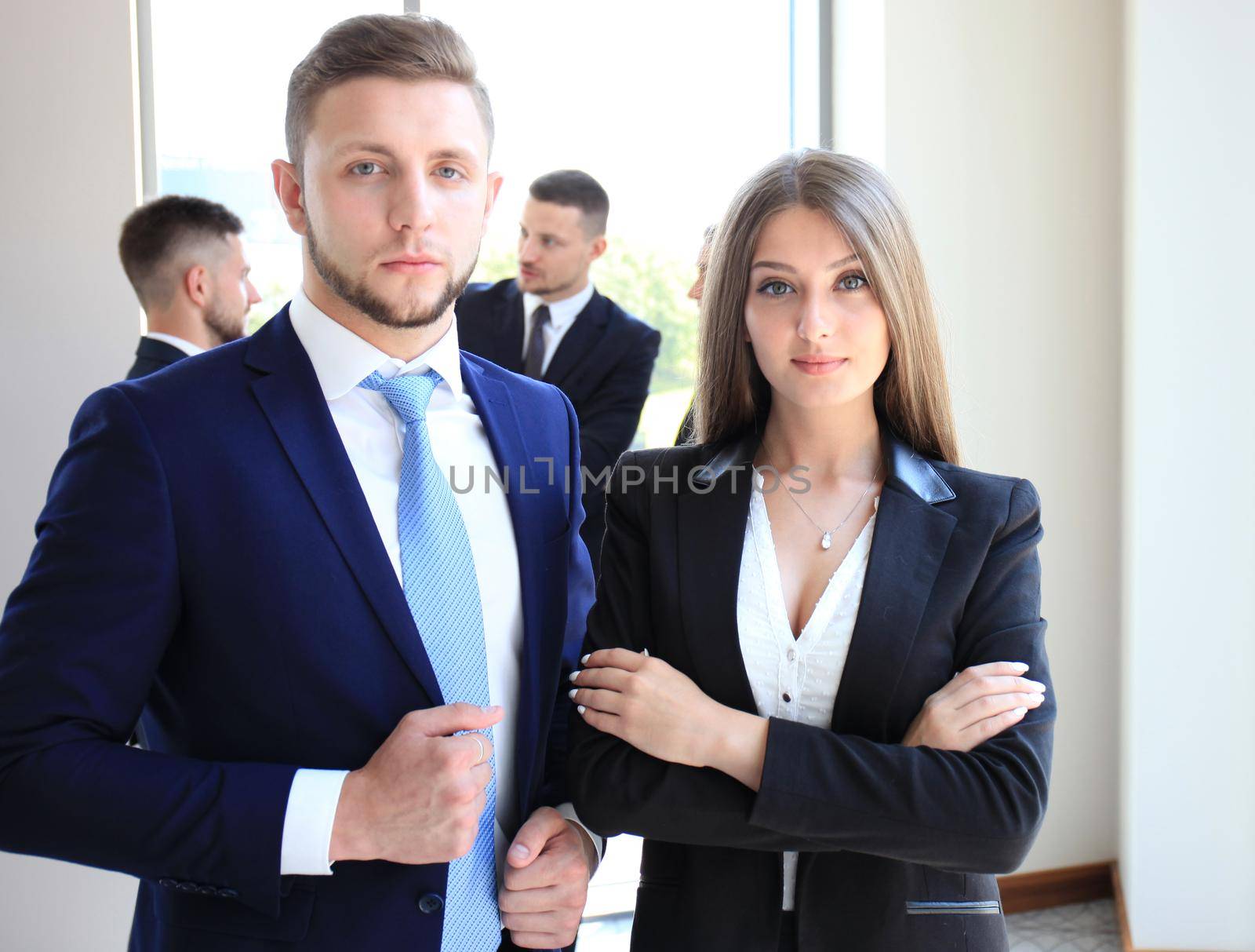 Group of business people at a meeting on the background of office. Focus on a beautiful brunet
