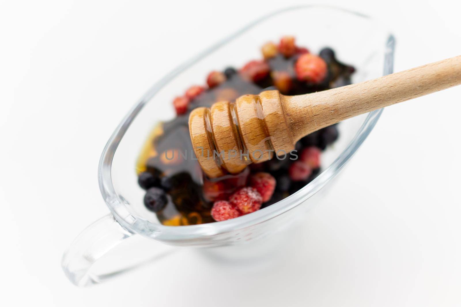 Honey with fresh raw berries forest strawberry. High quality photo