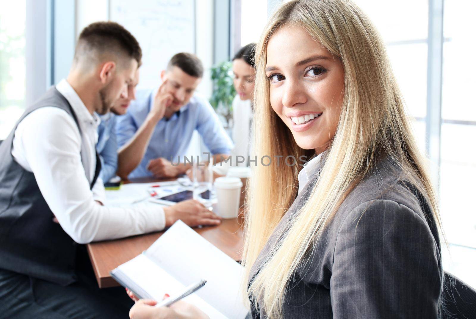 Face of beautiful woman on the background of business people